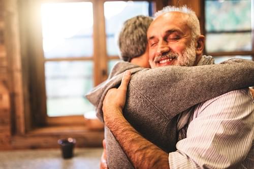 A relieved couple hugging