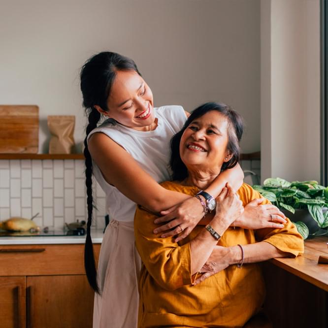 A couple embracing in their kitchen